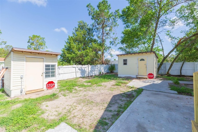 9445 Cardy St, New Port Richey, FL 34654 - fenced backyard featuring a storage unit and a patio