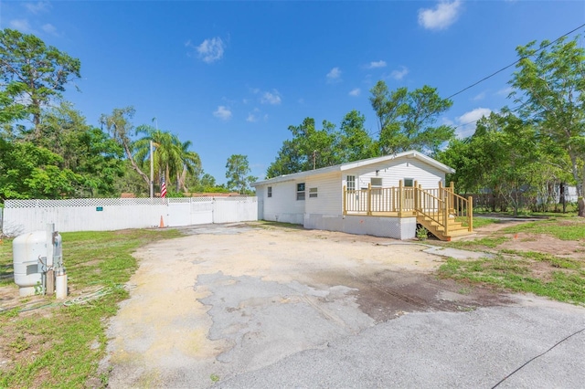 9445 Cardy St, New Port Richey, FL 34654 - back of house featuring a wooden deck