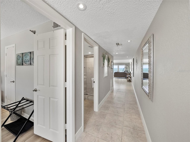 19440 Gulf Blvd Unit 301, Indian Rocks Beach, FL 33785 - hall with a textured ceiling and light tile patterned floors