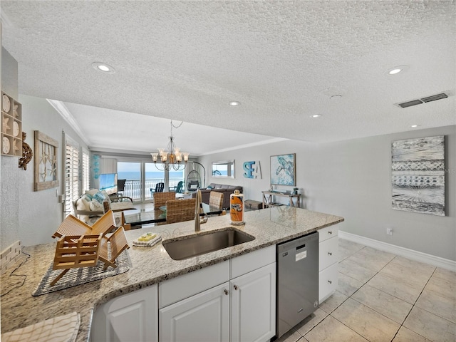19440 Gulf Blvd Unit 301, Indian Rocks Beach, FL 33785 - kitchen with dishwasher, open floor plan, a textured ceiling, white cabinetry, and light stone counters