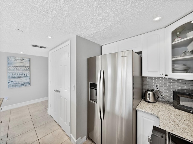 19440 Gulf Blvd Unit 301, Indian Rocks Beach, FL 33785 - kitchen featuring stainless steel refrigerator with ice dispenser, white cabinets, decorative backsplash, glass insert cabinets, and a textured ceiling