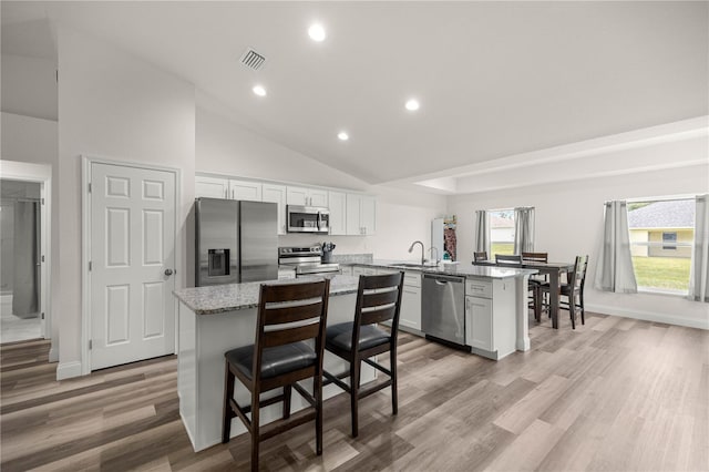 231 Marion Oaks Trl, Ocala, FL 34473 - kitchen featuring appliances with stainless steel finishes, a peninsula, recessed lighting, a kitchen island, and light wood-style flooring