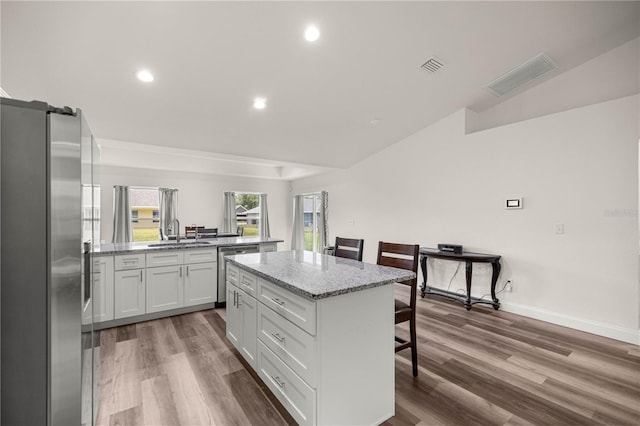 231 Marion Oaks Trl, Ocala, FL 34473 - kitchen featuring appliances with stainless steel finishes, a center island, a breakfast bar, wood finished floors, and recessed lighting