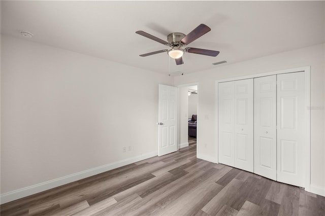 231 Marion Oaks Trl, Ocala, FL 34473 - unfurnished bedroom featuring wood finished floors, a closet, and ceiling fan