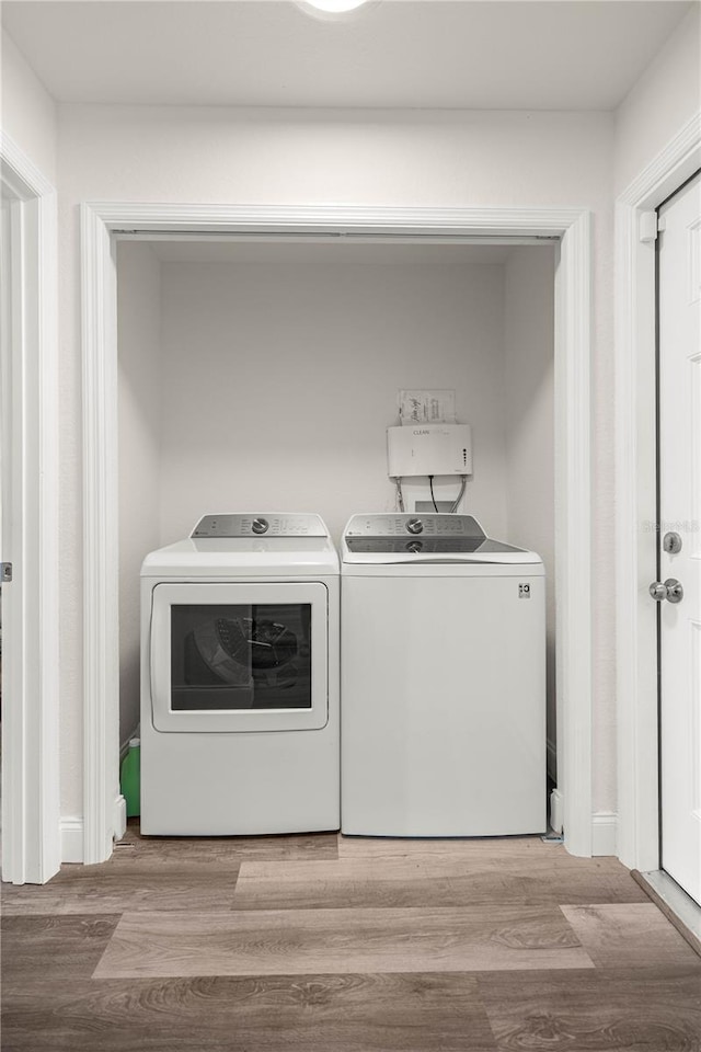 231 Marion Oaks Trl, Ocala, FL 34473 - washroom featuring washer and dryer and wood finished floors