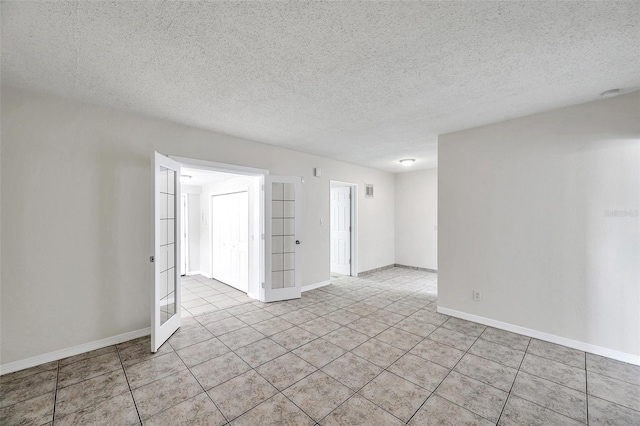 2509 W Crawford St, Tampa, FL 33614 - spare room featuring tile patterned floors and a textured ceiling