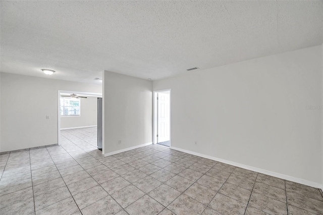 2509 W Crawford St, Tampa, FL 33614 - unfurnished room featuring light tile patterned flooring, a textured ceiling, and a ceiling fan