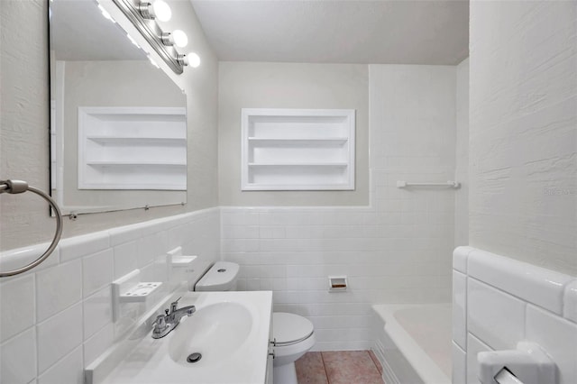 2509 W Crawford St, Tampa, FL 33614 - full bathroom with tile walls, tile patterned flooring, built in shelves, vanity, and wainscoting