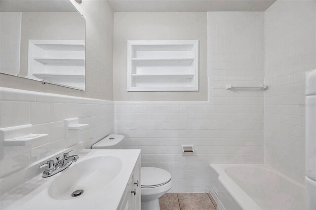 2509 W Crawford St, Tampa, FL 33614 - bathroom with tile walls, vanity, tile patterned flooring, and built in shelves