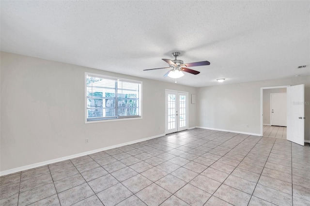 2509 W Crawford St, Tampa, FL 33614 - unfurnished room with french doors, light tile patterned floors, a textured ceiling, and ceiling fan