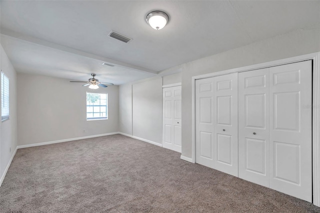 2509 W Crawford St, Tampa, FL 33614 - unfurnished bedroom with carpet, multiple closets, and ceiling fan