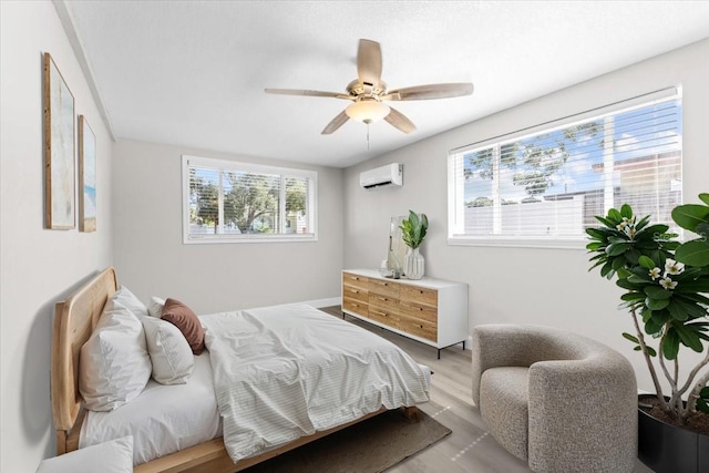 4718 W Oklahoma Ave, Tampa, FL 33616 - bedroom with a wall mounted AC, wood finished floors, and ceiling fan