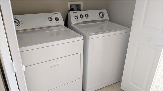 5000 Culbreath Key Way Unit 1-220, Tampa, FL 33611 - laundry room with independent washer and dryer and light tile patterned floors