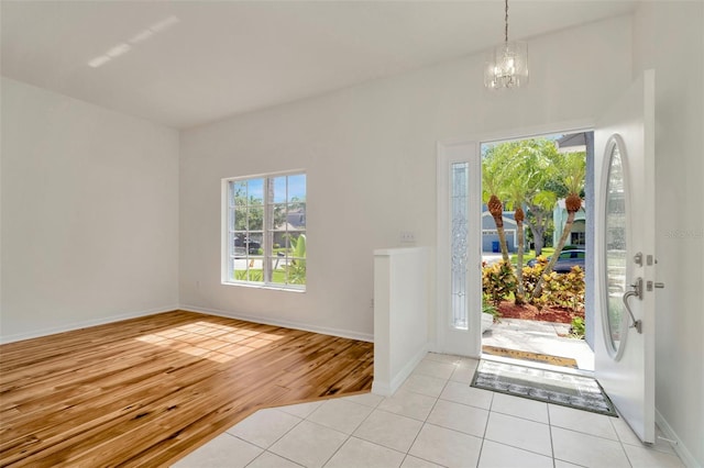 1734 Mapleleaf Blvd, Oldsmar, FL 34677 - entrance foyer with healthy amount of natural light, a chandelier, and tile patterned floors