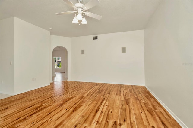 1734 Mapleleaf Blvd, Oldsmar, FL 34677 - spare room featuring arched walkways, light wood-type flooring, and ceiling fan