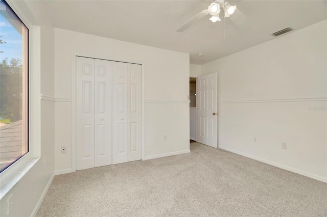 1734 Mapleleaf Blvd, Oldsmar, FL 34677 - unfurnished bedroom featuring carpet flooring, a closet, and ceiling fan