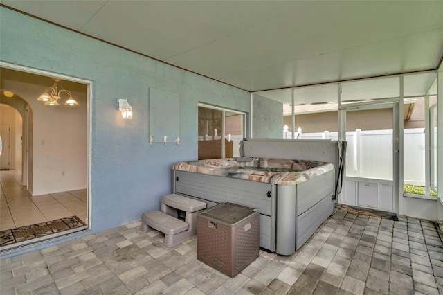 1734 Mapleleaf Blvd, Oldsmar, FL 34677 - sunroom / solarium with a jacuzzi, a chandelier, and arched walkways