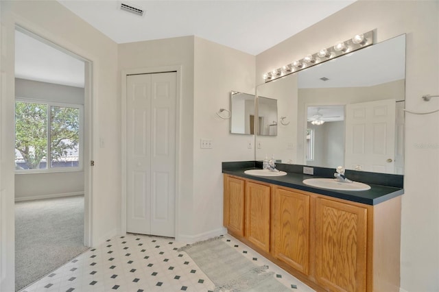 1734 Mapleleaf Blvd, Oldsmar, FL 34677 - bathroom featuring double vanity, tile patterned floors, ceiling fan, and a closet