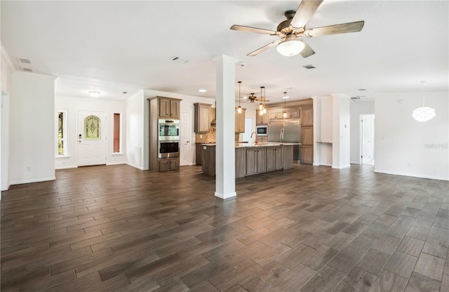 6728 Sutton Oaks Ln, Zephyrhills, FL 33541 - unfurnished living room featuring dark wood-type flooring and ceiling fan