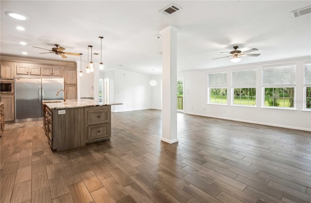 6728 Sutton Oaks Ln, Zephyrhills, FL 33541 - kitchen featuring built in appliances, ceiling fan, open floor plan, a center island with sink, and recessed lighting