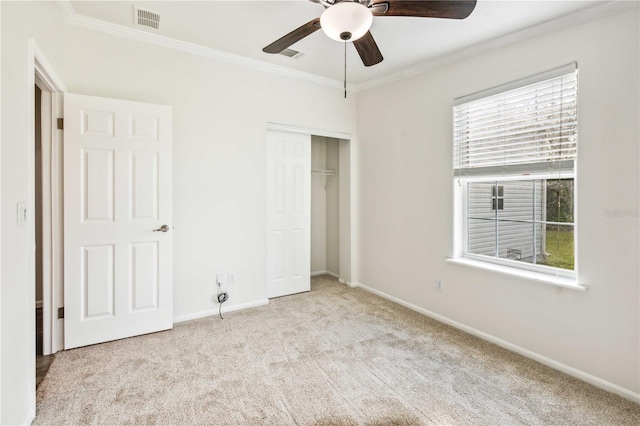 6728 Sutton Oaks Ln, Zephyrhills, FL 33541 - unfurnished bedroom with ornamental molding, carpet, a closet, and ceiling fan