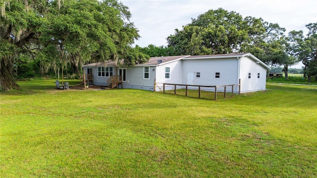 6728 Sutton Oaks Ln, Zephyrhills, FL 33541 - back of house featuring a lawn