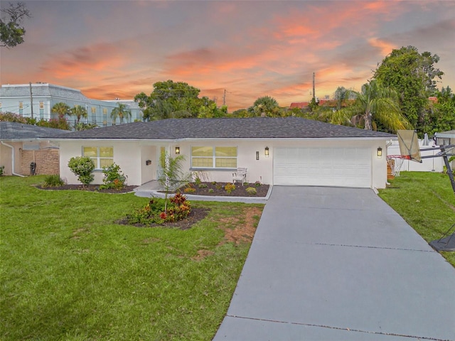 1723 Cypress Ave, Belleair, FL 33756 - single story home featuring a lawn, a garage, stucco siding, and concrete driveway