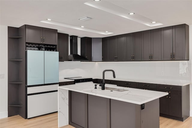 1723 Cypress Ave, Belleair, FL 33756 - kitchen with wall chimney range hood, light stone countertops, light wood-style floors, freestanding refrigerator, and recessed lighting
