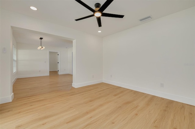 1723 Cypress Ave, Belleair, FL 33756 - unfurnished room with light wood-type flooring, recessed lighting, ceiling fan, and a chandelier