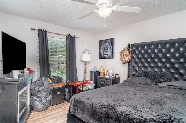 1827 Peaceful Palm St, Ruskin, FL 33570 - bedroom featuring wood finished floors, a ceiling fan, and a textured ceiling