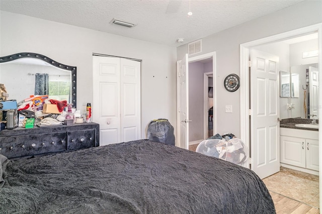 1827 Peaceful Palm St, Ruskin, FL 33570 - bedroom featuring a textured ceiling, ensuite bathroom, and a closet