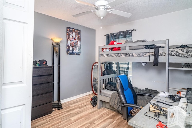 1827 Peaceful Palm St, Ruskin, FL 33570 - bedroom featuring wood finished floors, a textured ceiling, and a ceiling fan