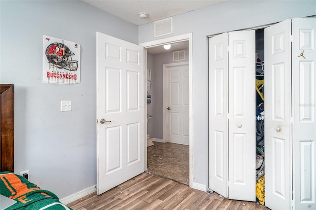 1827 Peaceful Palm St, Ruskin, FL 33570 - unfurnished bedroom with light wood-style floors and a closet