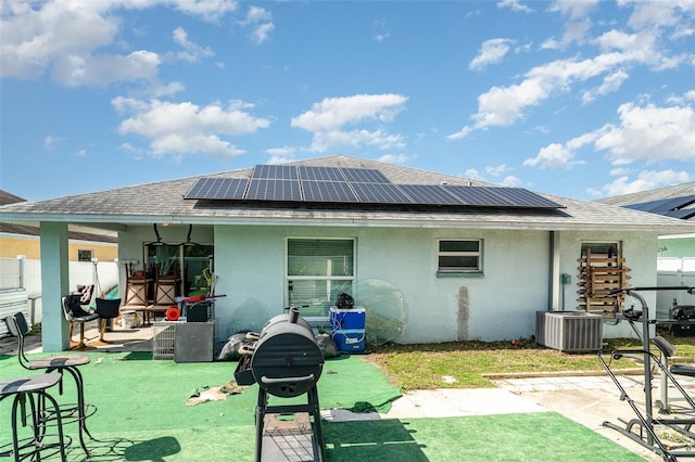 1827 Peaceful Palm St, Ruskin, FL 33570 - rear view of property with a patio, stucco siding, roof with shingles, and solar panels