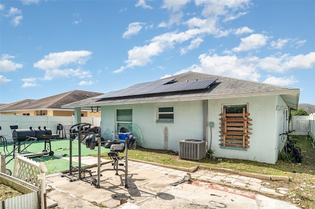 1827 Peaceful Palm St, Ruskin, FL 33570 - rear view of house featuring a patio area, a fenced backyard, stucco siding, and roof mounted solar panels