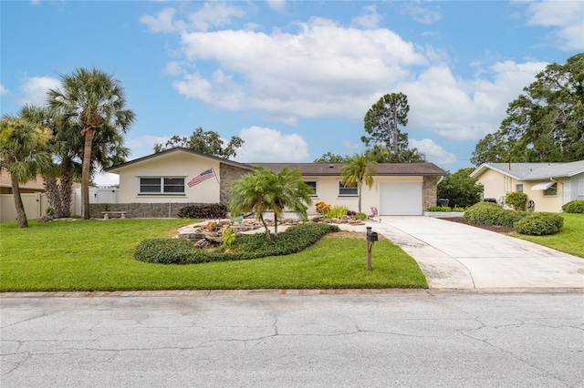 1251 Fairway Dr, Dunedin, FL 34698 - ranch-style house with an attached garage, driveway, stone siding, and a front yard