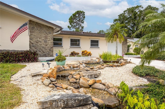 1251 Fairway Dr, Dunedin, FL 34698 - view of front of house featuring stucco siding and stone siding