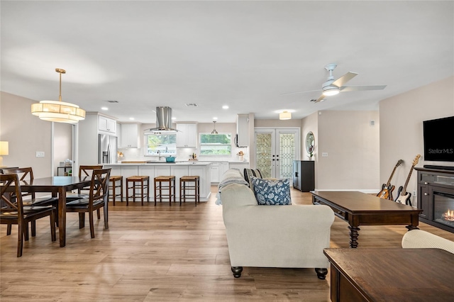 1251 Fairway Dr, Dunedin, FL 34698 - living room with light wood finished floors, ceiling fan, and recessed lighting