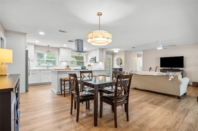 1251 Fairway Dr, Dunedin, FL 34698 - dining room with light wood-type flooring, a ceiling fan, and recessed lighting