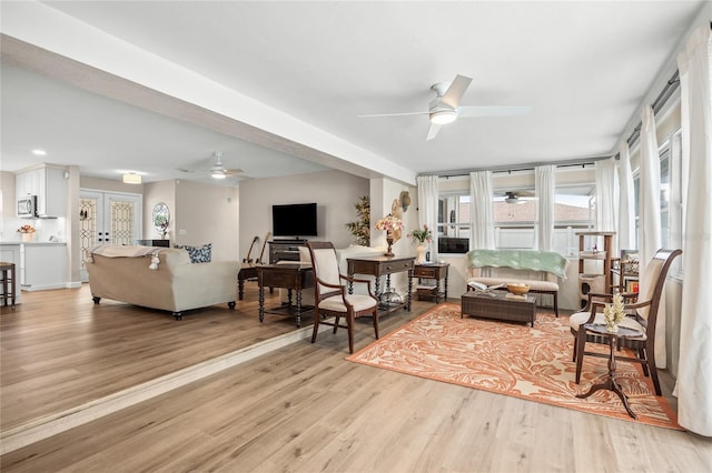 1251 Fairway Dr, Dunedin, FL 34698 - living room with ceiling fan and light wood-style floors