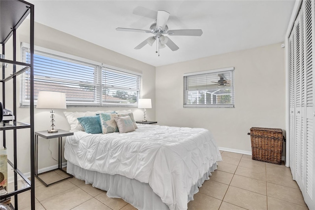 1251 Fairway Dr, Dunedin, FL 34698 - bedroom featuring light tile patterned floors, a closet, and a ceiling fan