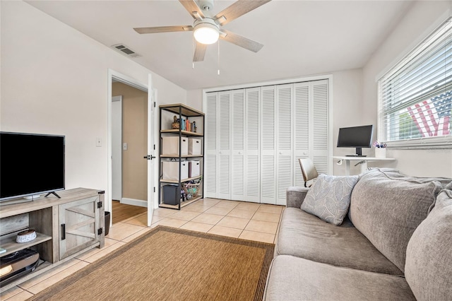 1251 Fairway Dr, Dunedin, FL 34698 - living room with light tile patterned flooring and a ceiling fan