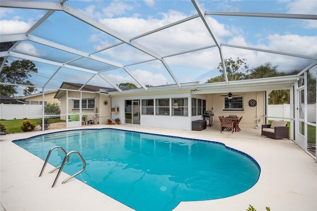 1251 Fairway Dr, Dunedin, FL 34698 - view of swimming pool with a patio, ceiling fan, glass enclosure, and area for grilling