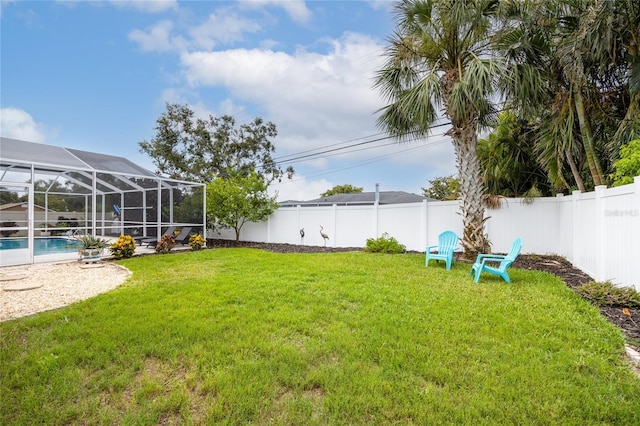 1251 Fairway Dr, Dunedin, FL 34698 - fenced backyard with a lanai