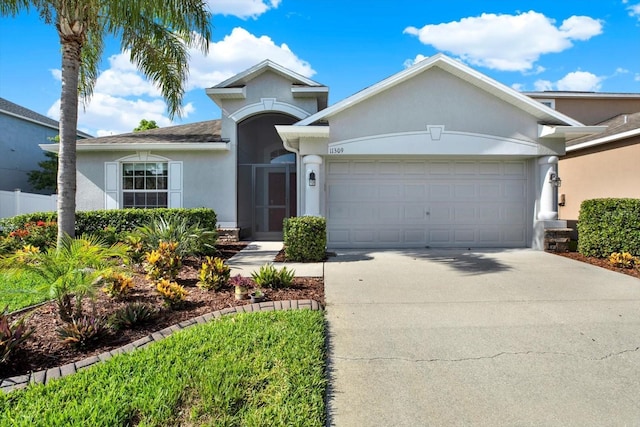 11309 Langworth Hill Ln, Riverview, FL 33579 - ranch-style home with stucco siding, an attached garage, and driveway
