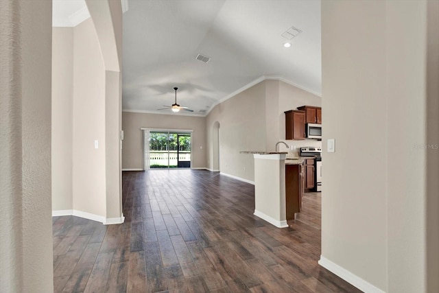 11309 Langworth Hill Ln, Riverview, FL 33579 - unfurnished living room with dark wood-style flooring, ceiling fan, crown molding, vaulted ceiling, and arched walkways