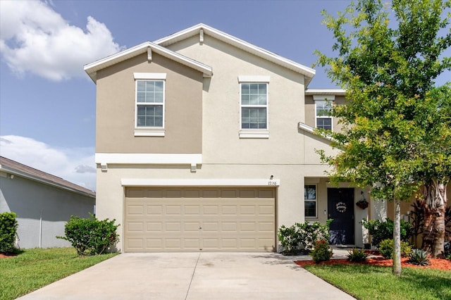 17156 Yellow Pine St, Wimauma, FL 33598 - view of front of property featuring concrete driveway, an attached garage, and stucco siding