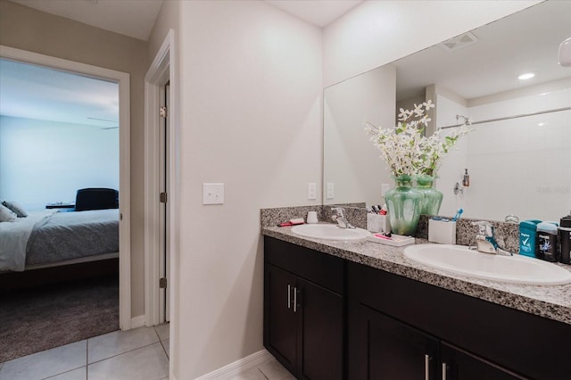 17156 Yellow Pine St, Wimauma, FL 33598 - full bathroom with double vanity, connected bathroom, tile patterned flooring, and a shower