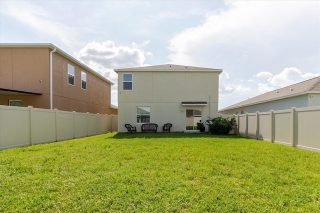 17156 Yellow Pine St, Wimauma, FL 33598 - rear view of house featuring a fenced backyard and stucco siding
