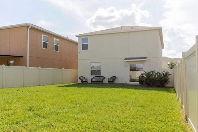 17156 Yellow Pine St, Wimauma, FL 33598 - back of house with stucco siding and a fenced backyard